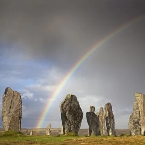 Standing Stones of Callanish bathed in sunlight with a rainbow arching across the sky in the background, near Carloway, Isle of Lewis, Outer Hebrides, Scotland, United Kingdom, Europe