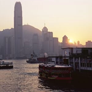 Star Ferry, Victoria Harbour and skyline of Hong Kong Island at sunset