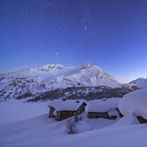 A starry night covering the Spluga huts submerged in snow near the Maloja Pass, Graubunden, Swiss Alps, Switzerland, Europe