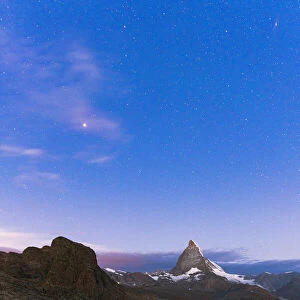 Starry sky before sunrise over Matterhorn and Riffelsee lake, Gornergrat, Zermatt