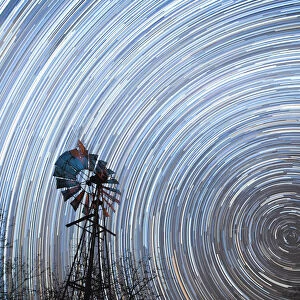 Startrail with windmill in foreground, Timbavati, South Africa, Africa