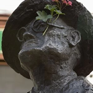 Statue of James Joyce with flower added, North Earl Street, Dublin, Republic of Ireland
