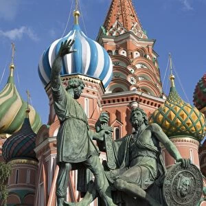 Statue of Minin and Pozharskiy and the onion domes of St. Basils Cathedral in Red Square, UNESCO World Heritage Site, Moscow, Russia, Europe