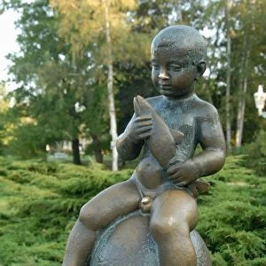 Statue of well-known boy holding a fish at spa Park of Solni and Lucni Spring in the spa town of Frantiskovy Lazne, Karlovarsky Region, West Bohemia, Czech