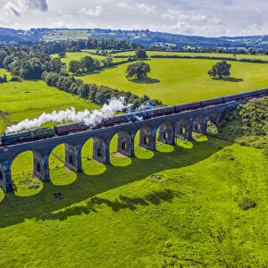 Steam locomotive crossing the Stanway Viaduct, Toddington, Gloucestershire, England
