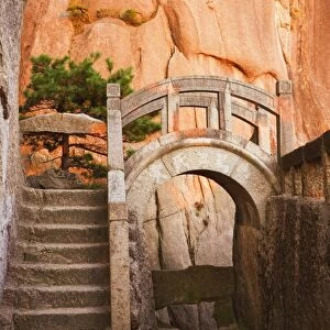 Steps, bridge, and last sunrays on rock face, White Cloud scenic area, Huang Shan