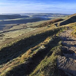 Steps up Mam Tor, view towards Rushup Edge, distant fields and hills in winter, Castleton, Peak District, Derbyshire, England, United Kingdom, Europe