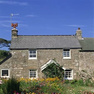 Stone cottage and colourful garden at New Grimsby on Tresco in the Scilly Isles