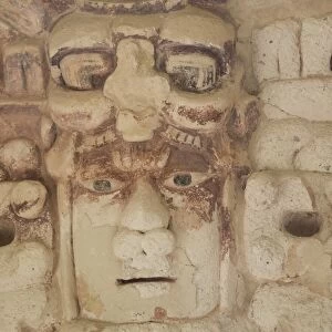 Stone mask of Mayan Sun God Kinichna, taken through protective glass, Becan, Mayan Ruins