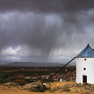 Storm clouds on windmills and castle, Consuegra, Don Quixote route, Toledo province