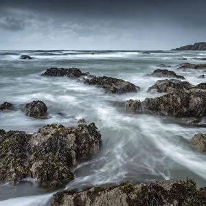 Stormy conditions on the rocky Bantham coast, looking across to Burgh Island, Devon