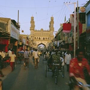 Street scene with bicycles and rickshaw and the Char Minar
