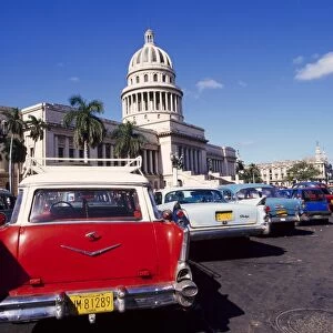 Street scene of taxis parked near the Capitolio Building in Central Havana