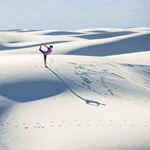 Stretching with a yoga pose in White Sands National Park, New Mexico