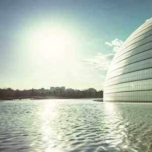 Sun and a partial view of Beijing Opera building with pool, Beijing, China, Asia