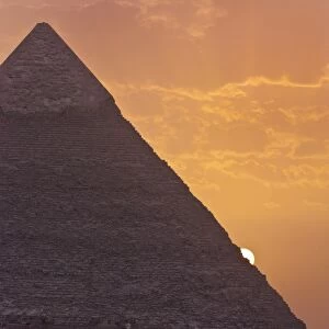 The sun setting behind the Pyramid of Khafre in Giza, UNESCO World Heritage Site, near Cairo, Egypt, North Africa, Africa