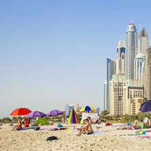 Sunbathers on the Public Dubai Beach at JBR (Jumeirah Beach Resort), Dubai, United Arab Emirates