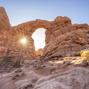 Sunburst through Turret Arch, Arches National Park, Utah, United States of America