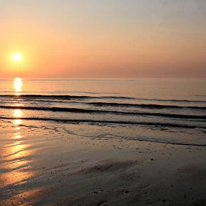 Sunrise over calm sea on the east coast of England, Walberswick, Suffolk, England