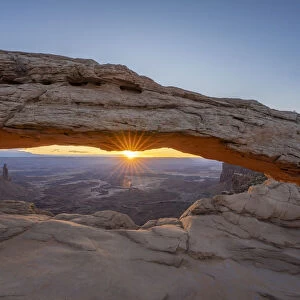 Sunrise at Mesa Arch with glowing arch and sunburst, Canyonlands National Park, Utah