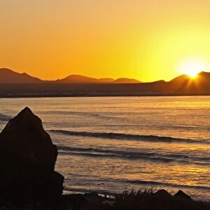 Sunset over the bay at Famara, Lanzarotes finest surf beach in the north west of the island
