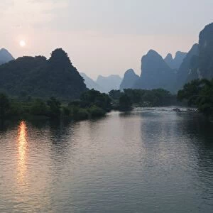 Sunset over karst limestone scenery on the Li river (Lijiang) in Yangshuo