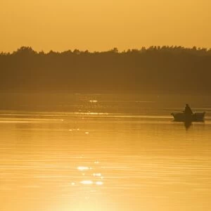 Sunset on lake and fishing boat