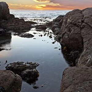 Sunset beyond the rocky coast, Elands Bay, South Africa, Africa