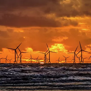 Sunset view over the Irish Sea towards the distant Walney Offshore wind farm, Walney Island, Cumbrian Coast, Cumbria, England, United Kingdom, Europe