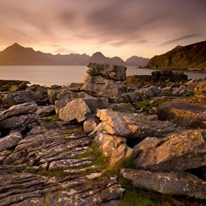 Sunset view over rocky foreshore to the Cuillin Hills from Elgol, Isle of Skye