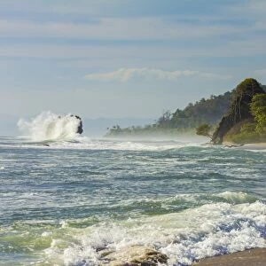 Surf breaking on sea stack and the Penon rock at this far south Nicoya Peninsula beach