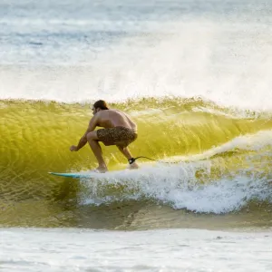 Surfer in barrel of this famous shore break wave near San Juan del Sur, Playa Maderas Beach, San Juan del Sur, Rivas, Nicaragua, Central America