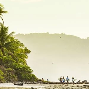 Surfers strolling on the beach at this hip southern Nicoya Peninsula surf resort