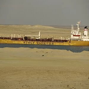 Tanker passing through Suez Canal with desert on either side, Egypt, North Africa, Africa