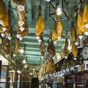 Tapas bar and restaurant with hams hanging from the ceiling