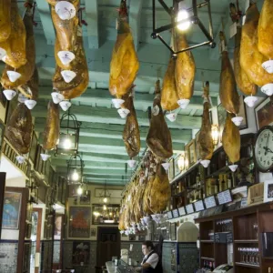 Tapas bar and restaurant with hams hanging from the ceiling