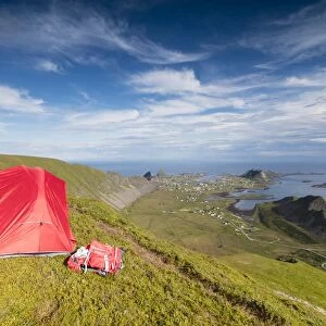 Tent on mountain ridge overlooking meadows and sea, Sorland, Vaeroy Island, Nordland county