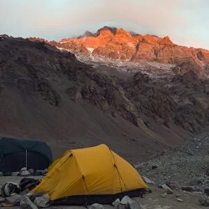 Tents at Plaza de Mulas base camp, with sunset on Aconcagua 6962m, highest peak in South America