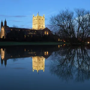 Tewkesbury Abbey reflected in water at dusk, Tewkesbury, Gloucestershire, England