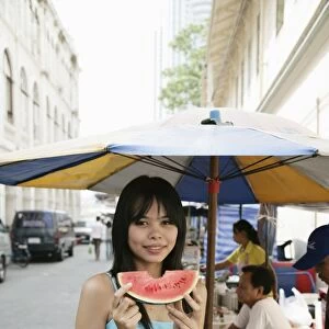 Thai woman with a slice of water melon