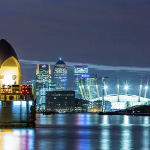 Thames Barrier, Millennium Dome (O2 Arena) and Canary Wharf at night, London, England