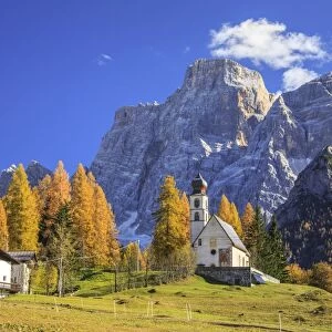 The tiny Church of Selva di Cadore, in the Dolomites, in autumn with the majestic Monte Pelmo in the background, Veneto, Italy, Europe