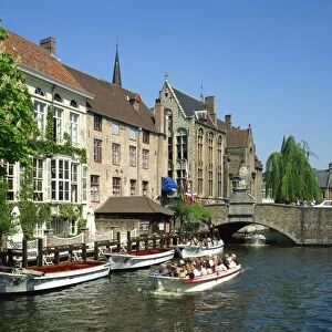 Tourist boat trip on canals of Bruges, Belgium, Europe