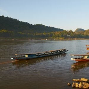 Tourist boats at sunset on the Mekong River, Luang Prabang, Laos, Indochina