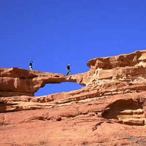Tourists climbing at Wadi Rum, Jordan, Middle East