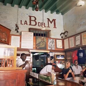 Tourists enjoy mojitos at the Bodegita del Medio, one of Havanas oldest bars