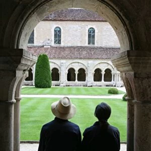 Tourists in Fontenay Cistercian Abbey cloister, UNESCO World Heritage Site