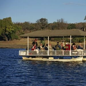 Tourists game viewing on boat on the Chobe River, Chobe National Park, Botswana, Africa