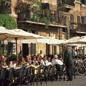 Tourists at a pavement cafe on the Piazza Navona in the city of Rome, Lazio