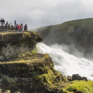 Tourists visiting Gullfoss (Golden Falls), a waterfall located in the canyon of the